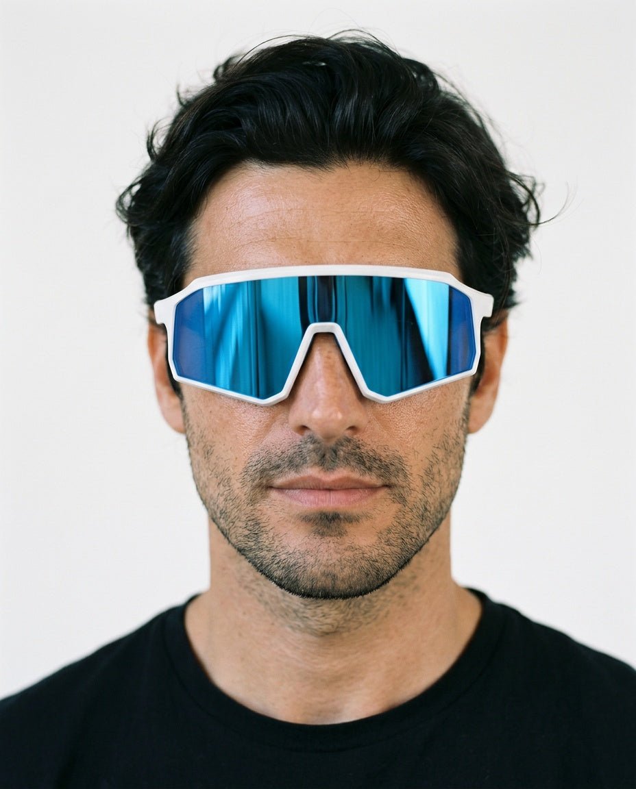 Brooklyn sport shield sunglasses in Blue / White, blue lens on white frame, worn by a man, front view