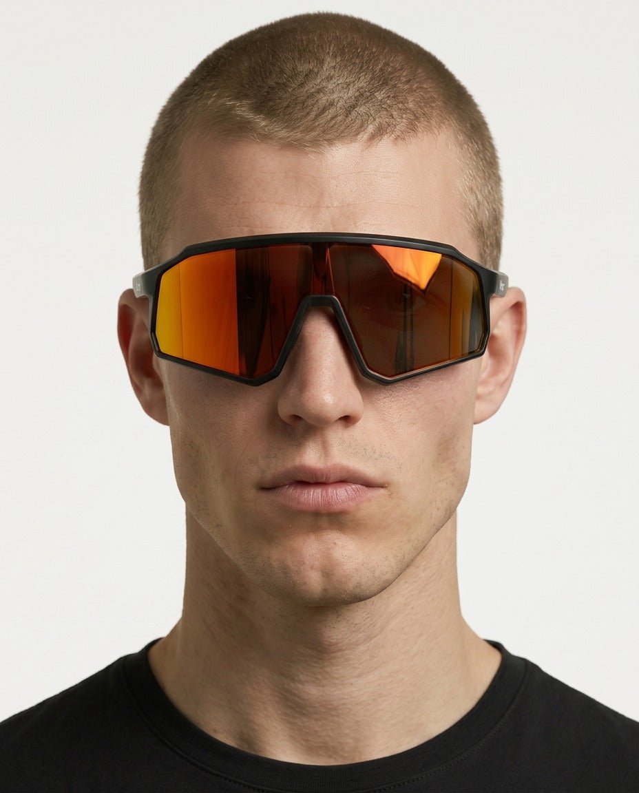 Brooklyn sport shield sunglasses in Orange / Black, orange lens on black frame, worn by a man, front view