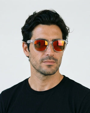 Delta 9 oversized round sunglasses in Orange / Clear, orange lens on clear frame, worn by a man, front view