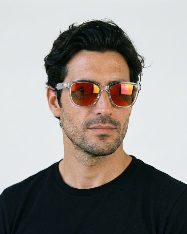 Delta 9 oversized round sunglasses in Orange / Clear, orange lens on clear frame, worn by a man, front view