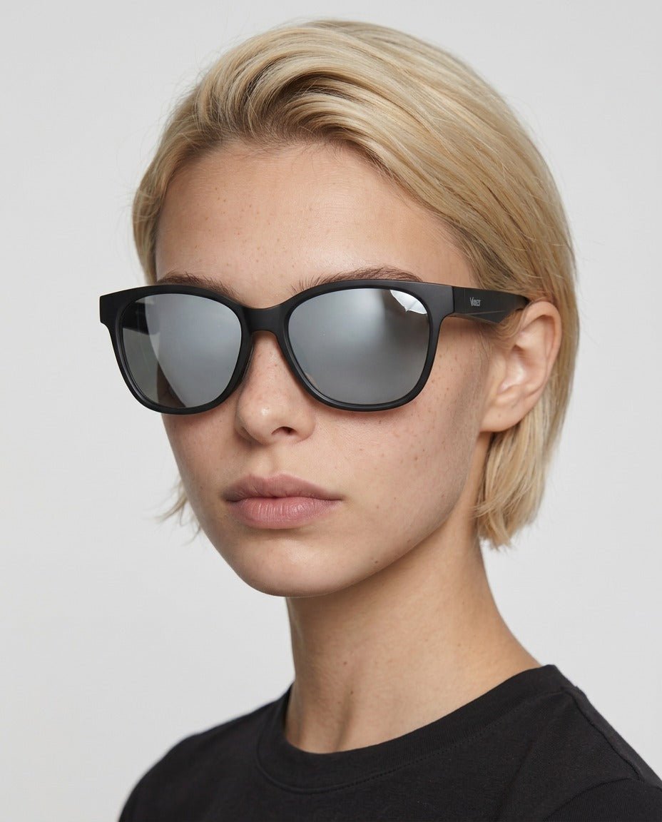 Delta 9 oversized round sunglasses in Grey / Black, grey lens on black frame, worn by a woman, front view