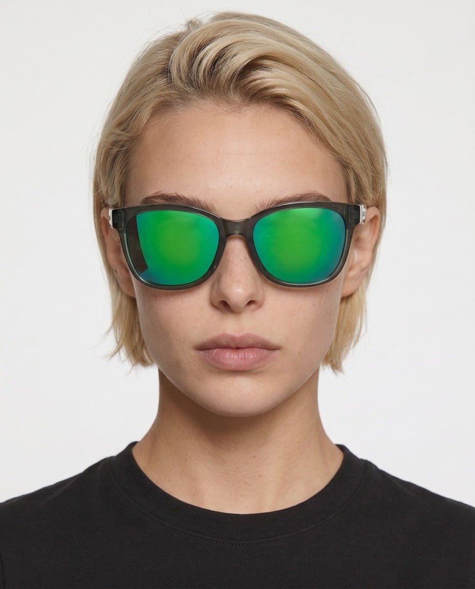 Delta 9 oversized round sunglasses in Green / Smoke Grey, green lens on smoke grey frame, worn by a woman, front view