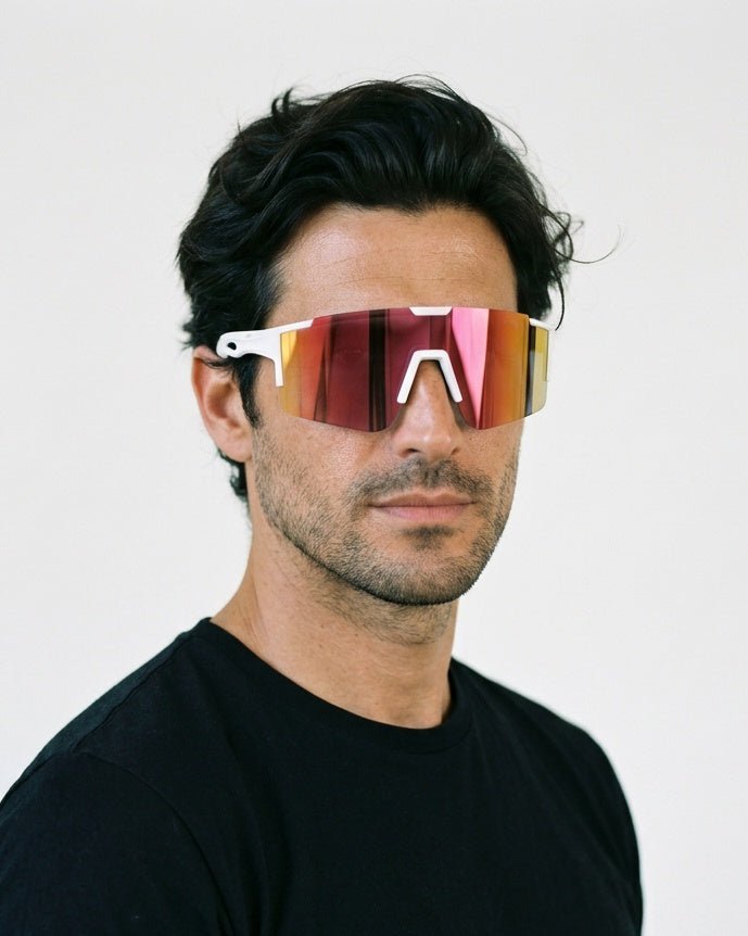 Dial Up sport shield sunglasses in Pink / White, pink lens on white frame, worn by a man, front view