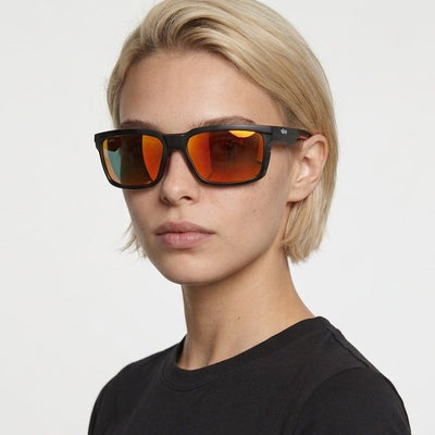 Flux sport wrap sunglasses in Orange / Black, orange lens on black frame, worn by a woman, front view