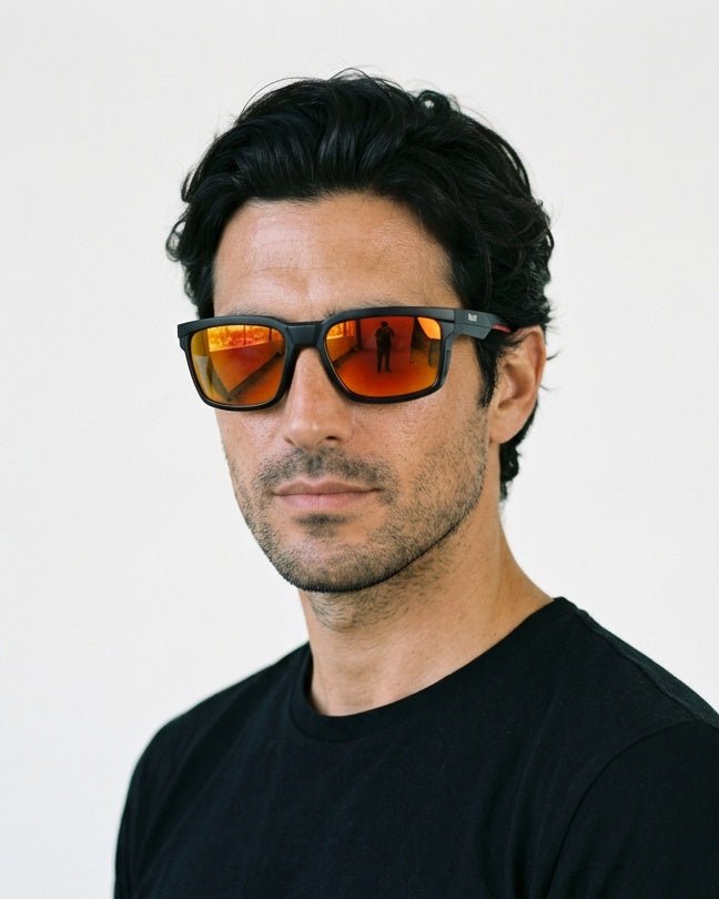 Flux sport wrap sunglasses in Orange / Black, orange lens on black frame, worn by a man, front view