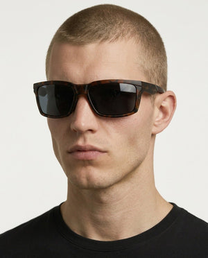 Flux sport wrap sunglasses in Black / Tortoise, black lens on tortoise frame, worn by a man, front view