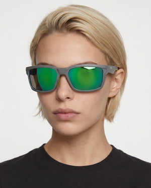 Flux sport wrap sunglasses in Green / Smoke Grey, green lens on smoke grey frame, worn by a woman, front view