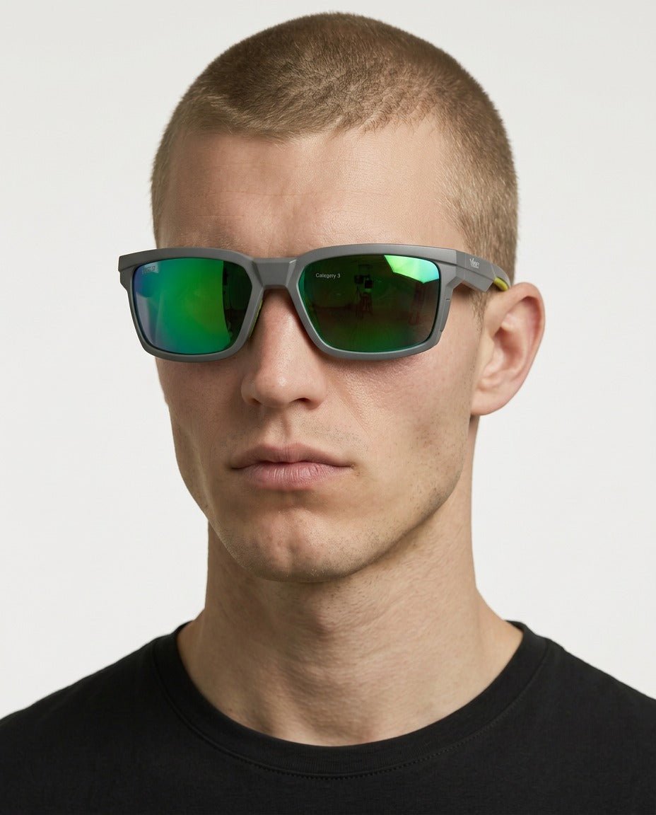 Flux sport wrap sunglasses in Green / Smoke Grey, green lens on smoke grey frame, worn by a man, front view