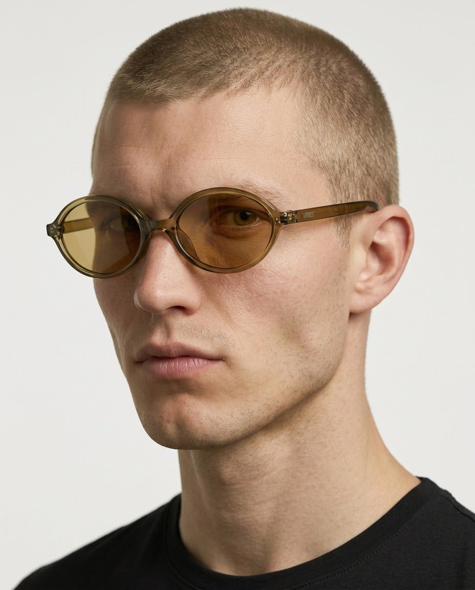 Mojave slim oval metal sunglasses in Gold / Gold, gold lens on gold frame, worn by a man, front view