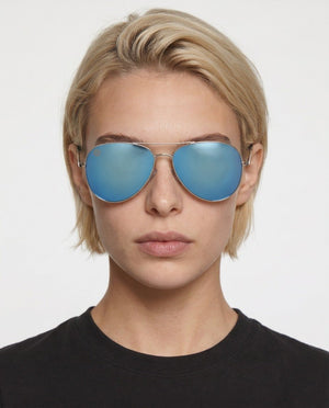 Nexus metal aviator sunglasses in Blue / Silver, blue lens on silver frame, worn by a woman, front view