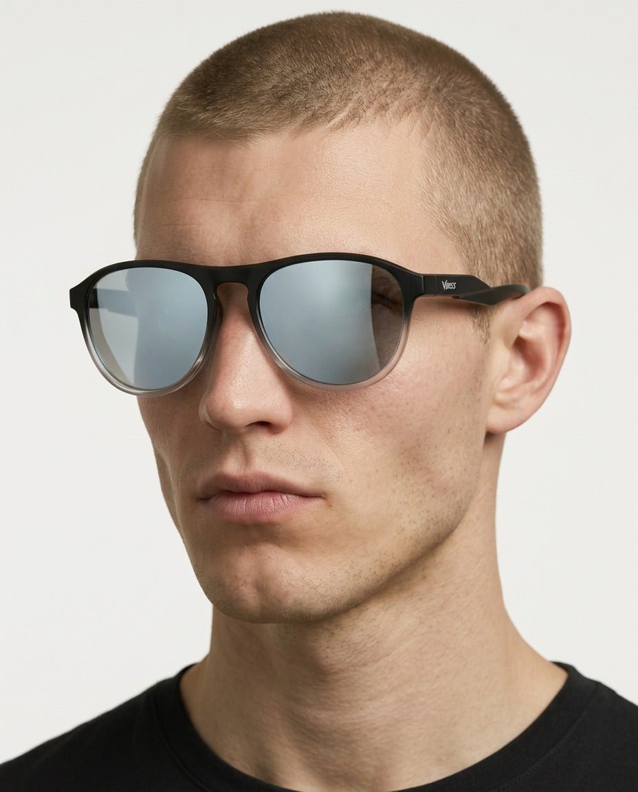 Orbit rounded aviator sunglasses in Silver / Black, silver lens on black frame, worn by a man, front view