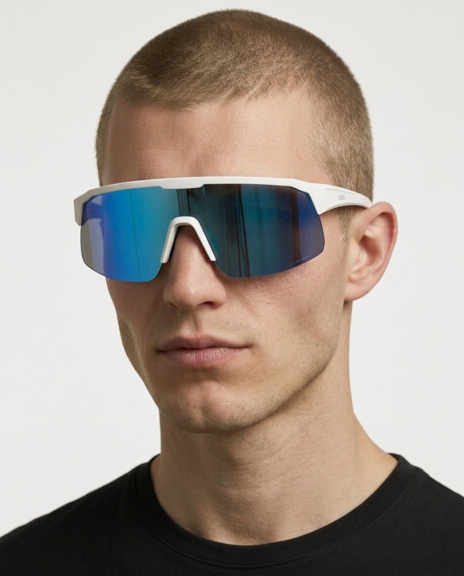 Rialto one-piece shield sunglasses in Blue / White, blue lens on white frame, worn by a man, front view