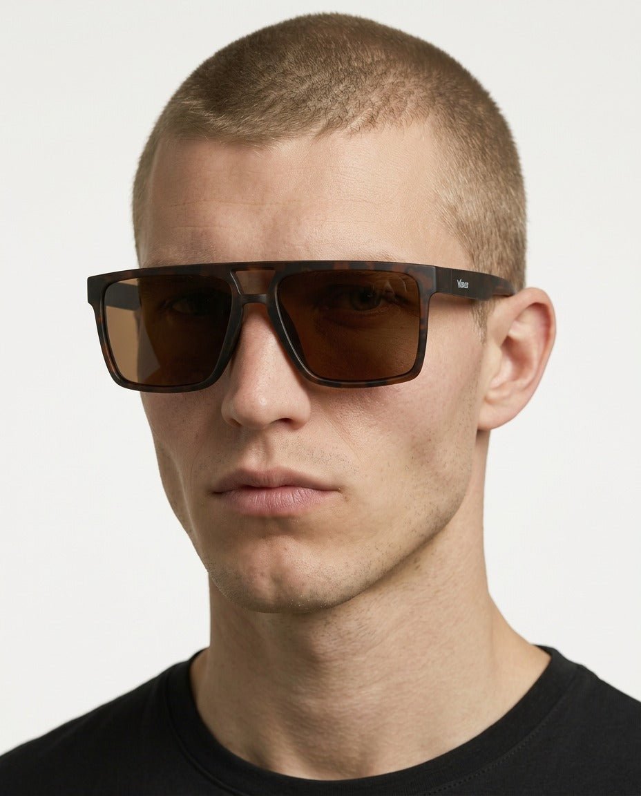 Sasha flat-top square sunglasses in Tea / Tortoise, tea lens on tortoise frame, worn by a man, front view