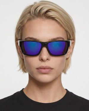 Specter slim wrap sunglasses in Purple / Black, purple lens on black frame, worn by a woman, front view