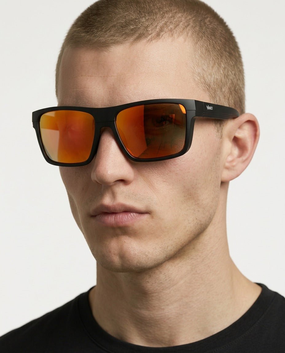 Theo bold wrap sunglasses in Orange / Black, orange lens on black frame, worn by a man, front view