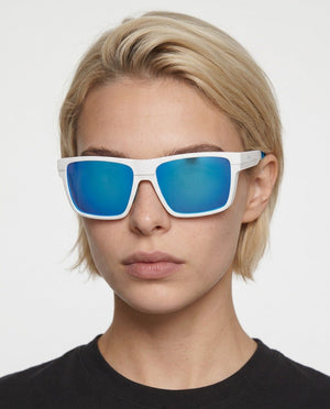 Theo bold wrap sunglasses in Blue / White, blue lens on white frame, worn by a woman, front view