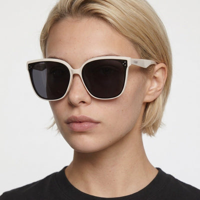 Vesper oversized square sunglasses in Black / Cream, black lens on cream frame, worn by a woman, front view