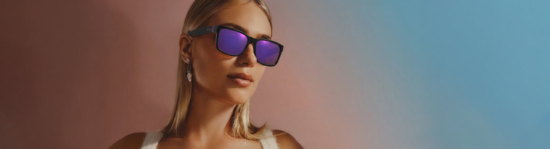 Woman wearing sunglasses with a gradient background