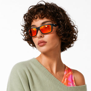 Flux sport wrap sunglasses in Orange / Black, orange lens on black frame, worn, side view