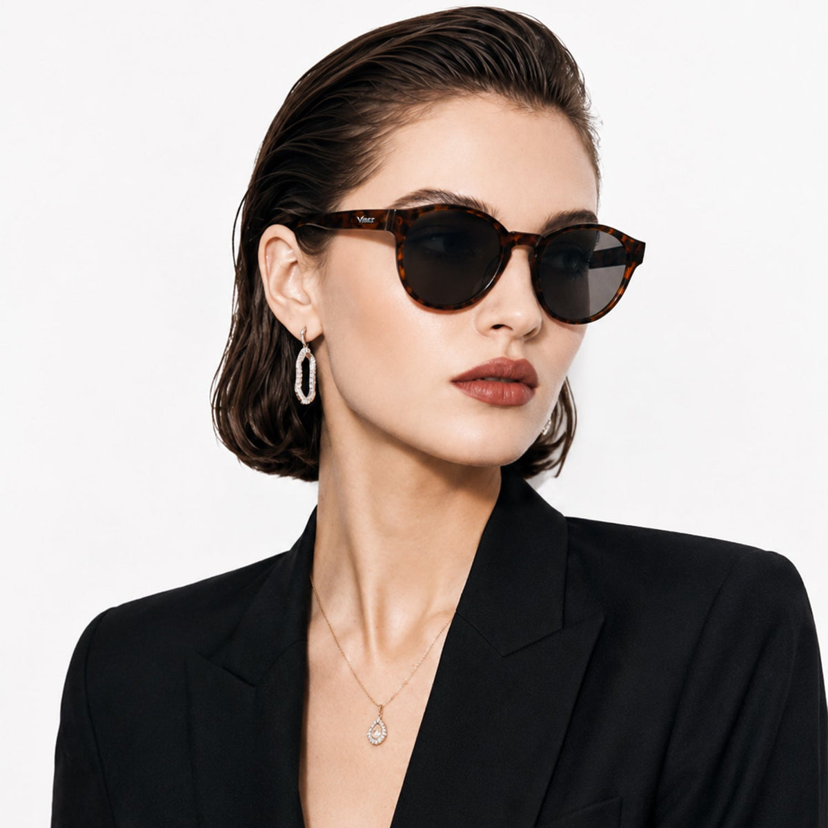 Hollis retro round sunglasses in Black / Tortoise, black lens on tortoise frame, worn, side view