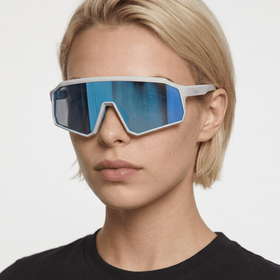 Brooklyn sport shield sunglasses in Blue / White, blue lens on white frame, worn by a woman, front view