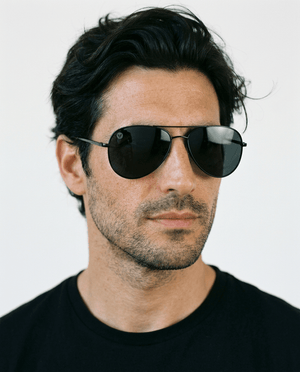 Nexus metal aviator sunglasses in Grey / Black, grey lens on black frame, worn by a man, front view