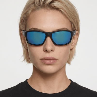 Nova sport wrap sunglasses in Blue / Black, blue lens on black frame, worn by a woman, front view