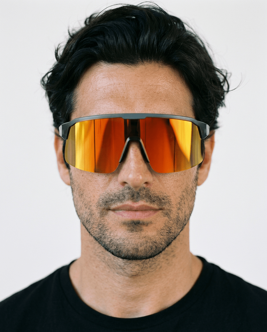 Rialto one-piece shield sunglasses in Orange / Black, orange lens on black frame, worn by a man, front view