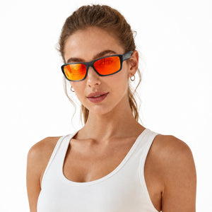 Nova sport wrap sunglasses in Orange / Smoke Grey, orange lens on smoke grey frame, worn by a woman, front view