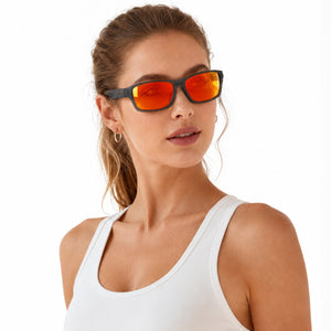 Nova sport wrap sunglasses in Orange / Smoke Grey, orange lens on smoke grey frame, worn by a woman, side view
