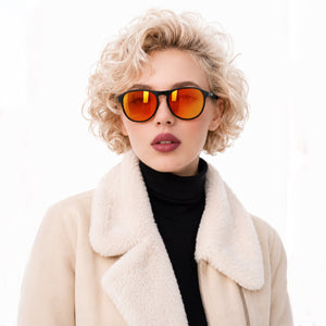 Orbit rounded aviator sunglasses in Orange / Black, orange lens on black frame, worn, front view