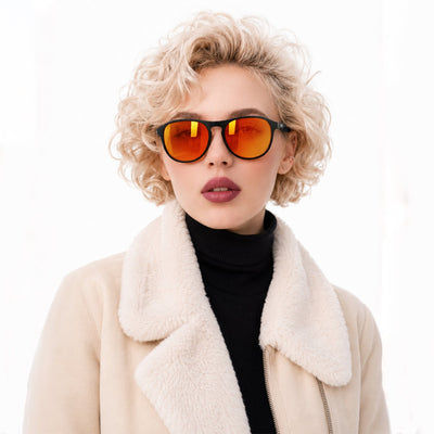 Orbit rounded aviator sunglasses in Orange / Black, orange lens on black frame, worn, front view