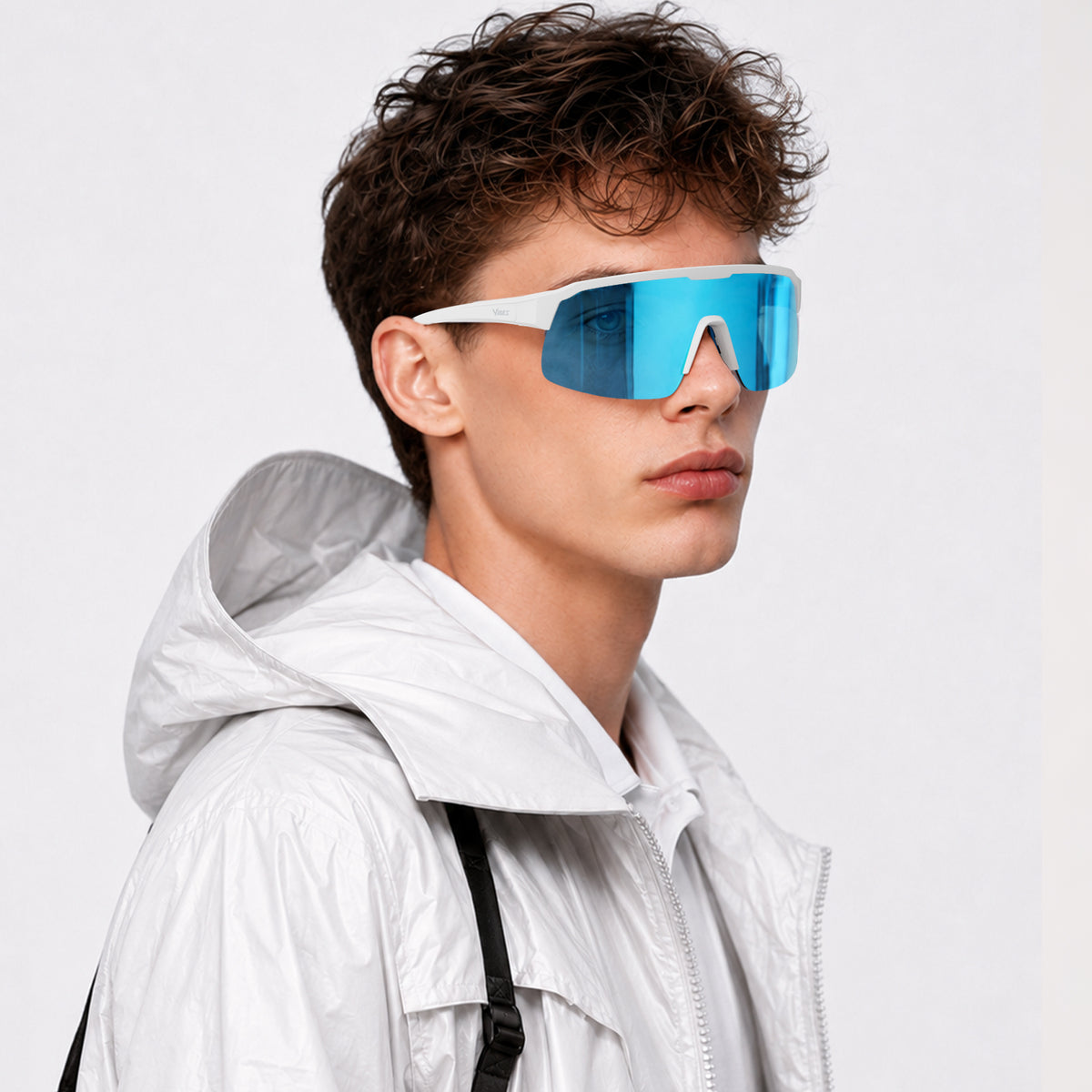 Rialto one-piece shield sunglasses in Blue / White, blue lens on white frame, worn by a man, side view