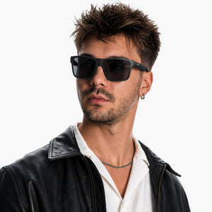 Theo bold wrap sunglasses in Black / Black, black lens on black frame, worn, side view