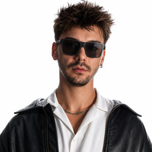 Theo bold wrap sunglasses in Black / Black, black lens on black frame, worn, front view