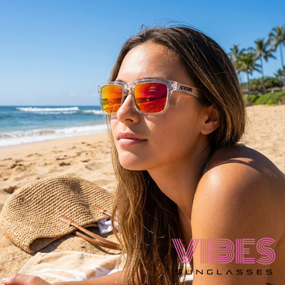 Woman wearing stylish mirrored sunglasses on sunny beach, perfect for summer fashion and outdoor vibes